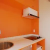Nestron Legend Two kitchen rendering with orange cabinetry, white countertops, sink, and cooktop
