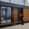 Nestron Legend 2 modular tiny home with wood-paneled exterior in a warehouse