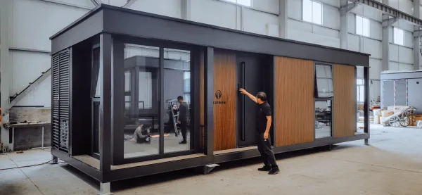 Nestron Legend Two exterior rendering with large glass windows, wood facade panels, and an entry door