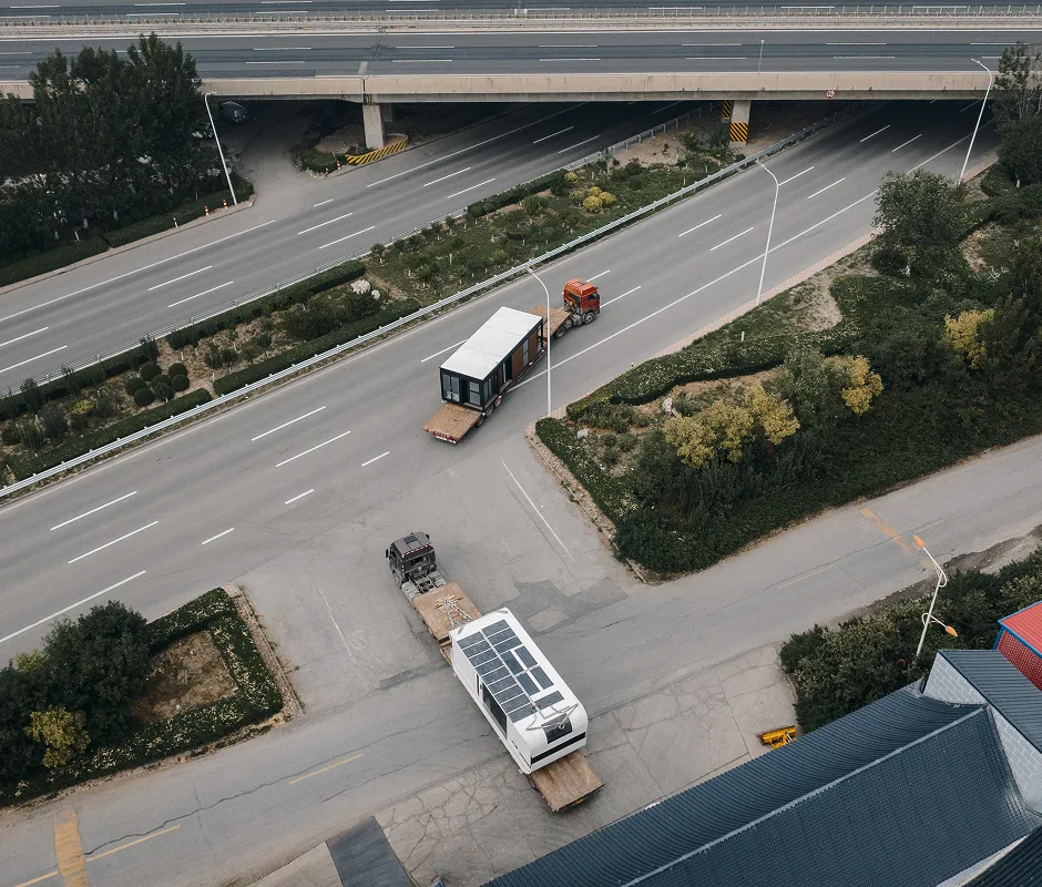 Aerial view of vehicles traveling along a roadway, representing transportation or delivery