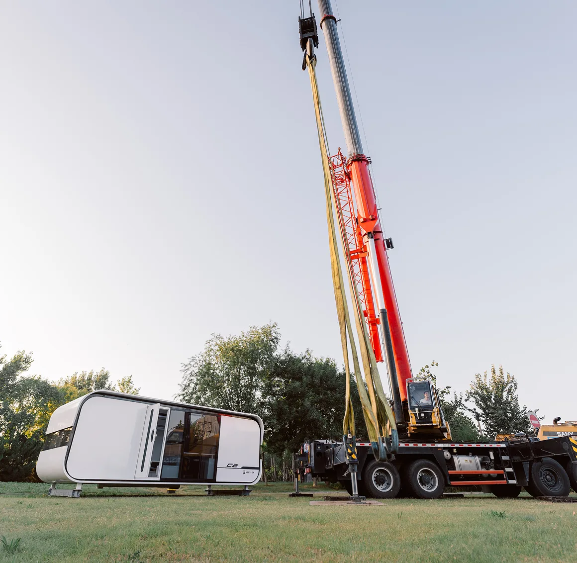 Crane lifting a modular home unit during installation