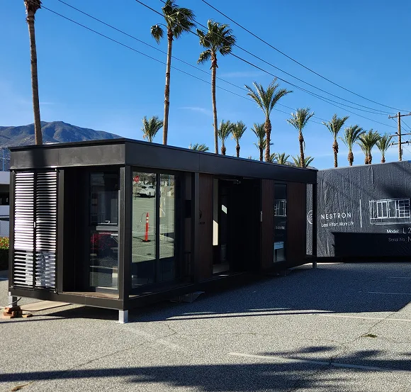 Exterior view of a dark modular building at a production or industrial site
