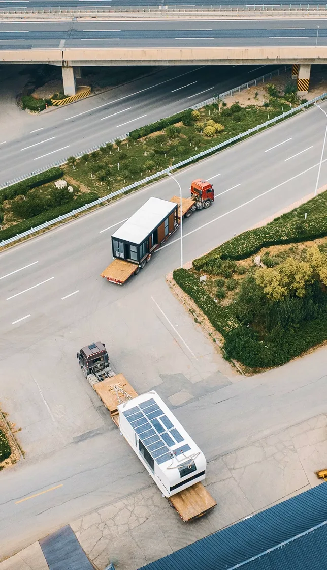 Aerial view of vehicles traveling along a roadway, representing transportation or delivery