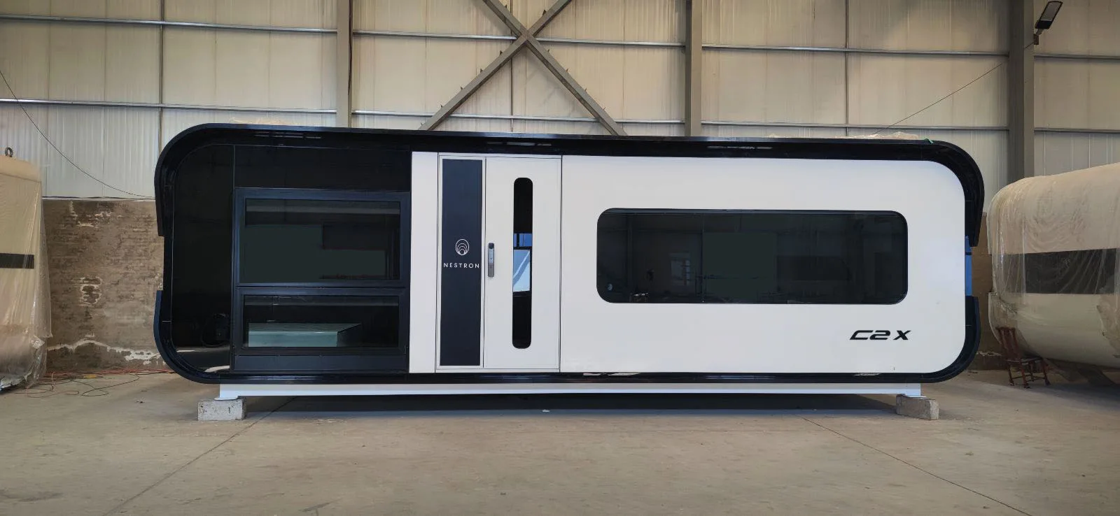 Nestron C2X modular home exterior parked inside warehouse facility