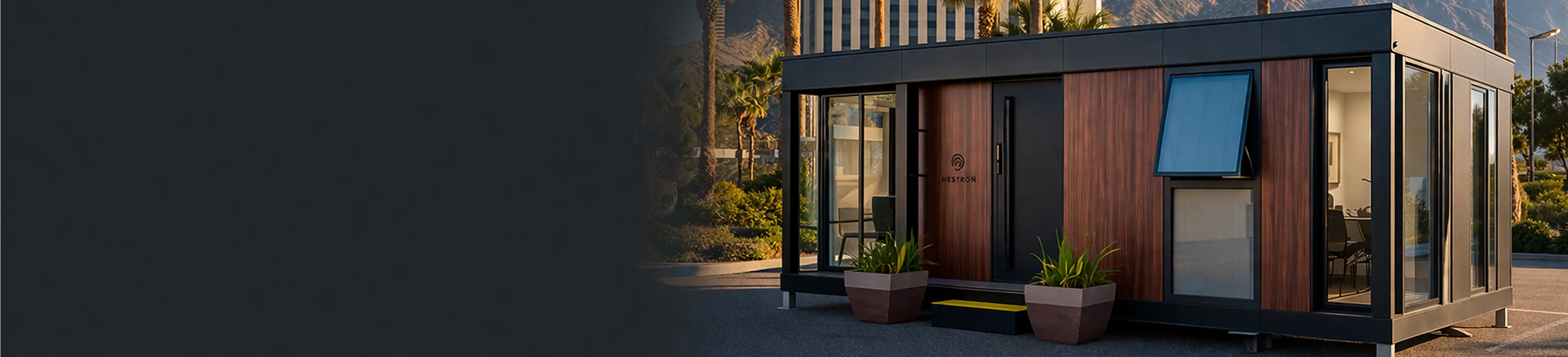 Exterior view of a modern showroom with floor-to-ceiling glass windows and warm interior lighting