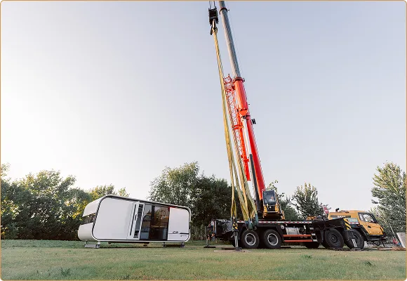 Crane lifting a modular home unit during installation