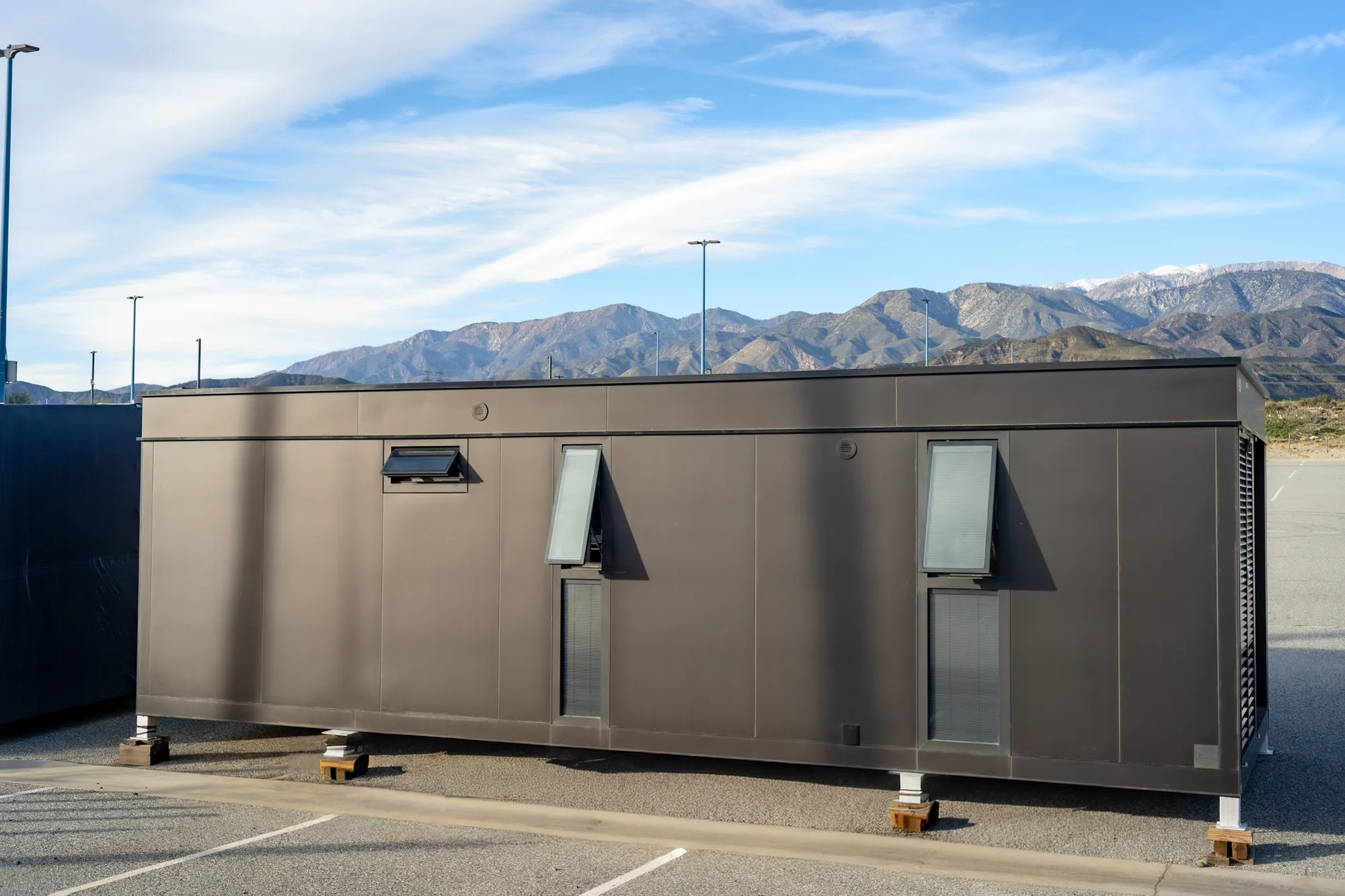 Nestron modular home exterior with solar panels and mountain view, sustainability feature